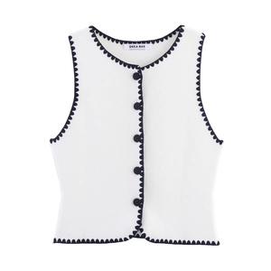 White knit vest with navy blue wave trim and five button closure shown in a flat lay