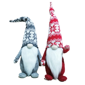 Pair of Christmas forest gnomes with knitted red and grey hats for holiday home decoration