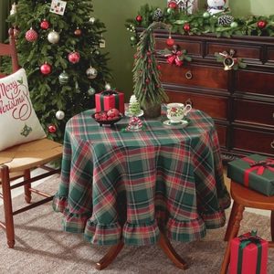 Christmas checkered round tablecloth with ruffled edges in a festive holiday scene setting