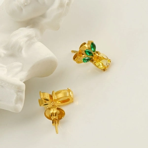 Gold pineapple stud earrings featuring yellow and green cubic zirconia with artistic bust