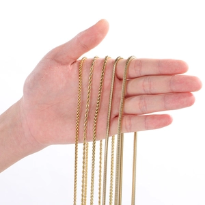 Detailed close-up of multiple 3mm gold chains including twist and snake bone styles