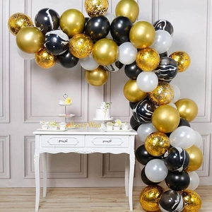 Detail of elegant black, gold, and white confetti balloon arch kit for party decoration