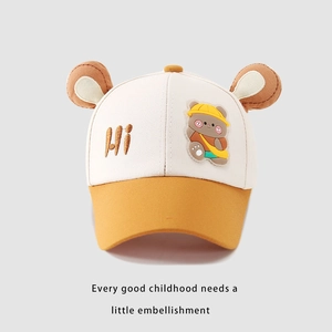 Detail of children's baseball cap with brown teddy ears and cute embroidered patch