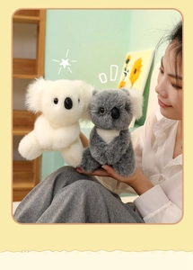 Detail of plush koala toys in white and grey colors with soft long fur texture