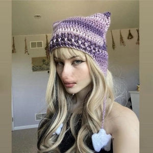Detail of purple gradient knit cat ear hat with long braids and white crochet stars