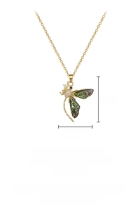Macro shot of dragonfly pendant showing titanium steel chain and crystal inlay details