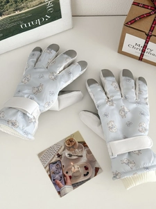 Detail of blue ski gloves with cute bunny prints, touchscreen fingertips, and adjustable cuffs