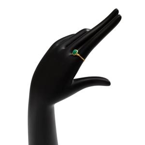 Detail of handmade gold wire-wrapped ring featuring a green natural gemstone bead
