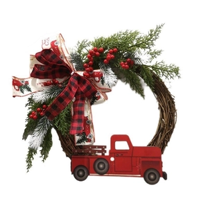 Christmas wreath with a red truck, green pine branches, berries and festive ribbons