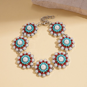 Detail of retro sunflower bracelet with white faux pearls and turquoise beads
