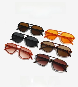 Detail view showing assorted thick-frame pilot sunglasses in various trendy colors