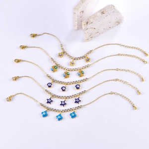 Gold stainless steel bracelets with zircon charms like evil eye, star and clover motifs
