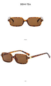 Detail view of demi-tea rectangular sunglasses with tortoise frame and gold metal accents