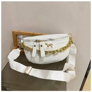 Detail of white woven texture fanny pack featuring gold chain and horse-shaped metal logo
