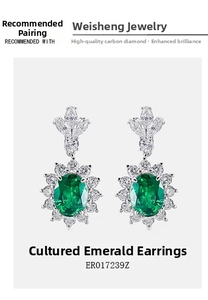 Macro detail of emerald earrings with sunflower petal halo and clover top design