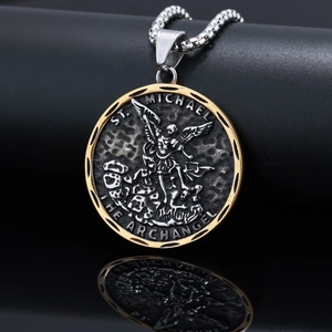Détail du pendentif rond de l'Archange Saint Michel en argent et or sur surface noire
