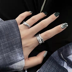 Minimalist silver lava textured irregular rings set worn by a model on index finger