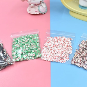 Detailed view of Christmas themed polymer clay slices for DIY crafts in clear packets