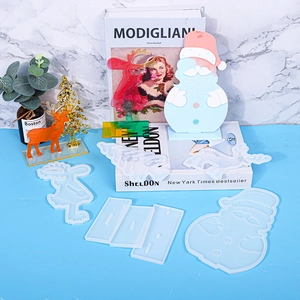 Christmas themed resin molds set featuring Santa and reindeer silicone shapes with bases