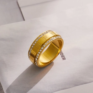 Macro shot of 18k gold-plated titanium ring with Roman numerals and diamond accents