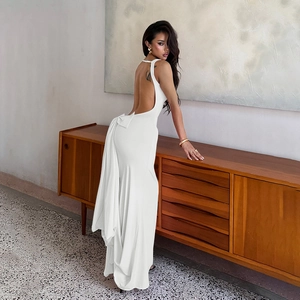 Close-up of the elegant backless design and bow detail on the white slim-fit maxi dress