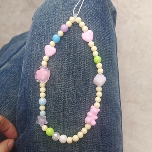Macro view of macaron colored beads with heart and star charms on phone strap