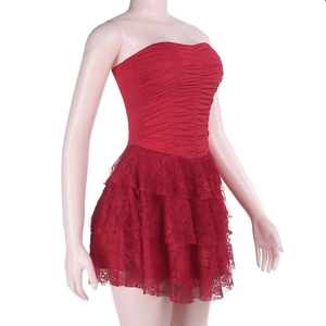 Detail of red tube top dress with tiered lace hem and intricate ruched fabric texture