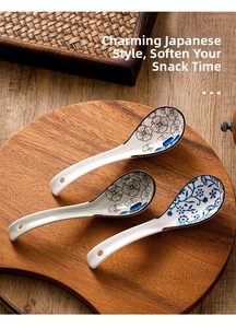 Three Japanese ceramic soup spoons with floral patterns in a wooden tray