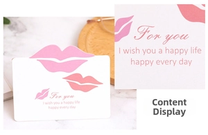 Detail of creative greeting card with pink lip prints and romantic heart elements