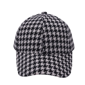 Classic black and white houndstooth baseball cap with curved brim and woven texture