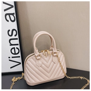 Detail view of pink jelly shell bag with chevron pattern and golden chain strap