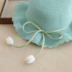 Mint green straw hat for girls with wavy brim, ribbon bow and tulip charms in 2025 summer style