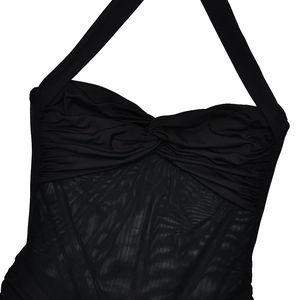 Close-up of black halter dress featuring ruched chest detail and sheer mesh paneling