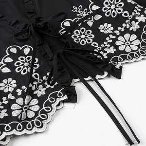 Women's black shirt featuring white floral embroidery, lace scalloped edges and tie front