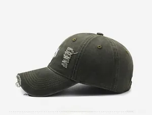 Detailed side view of washed denim baseball cap with distressed rips and white embroidery