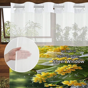 Sheer curtain with yellow floral print showing light filtering fabric and metal grommets