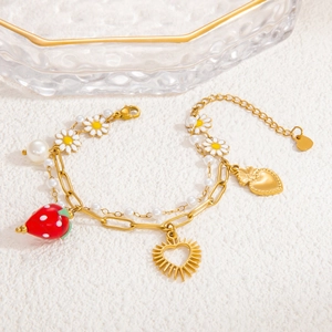 Detail of double-layer bracelet with strawberry, daisy charms and white pearls