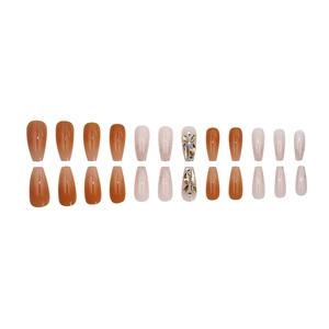 Long coffin press-on nails with amber and nude pink gradients and rhinestone accents