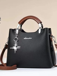 Black pebbled leather bucket bag with brown handles and a gold star charm pendant