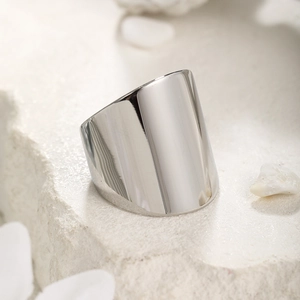 Macro detail of polished stainless steel wide band ring with modern geometric cut
