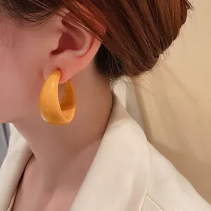 Chic vibrant yellow C-shaped hoop earrings for women with minimalist trendy design