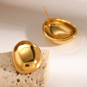 Polished 18k gold plated stainless steel oval stud earrings on stone display