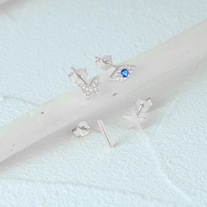Detailed macro view of S925 silver stud earring set with butterfly and zircon stones
