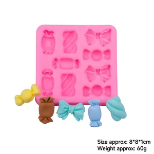 Pink silicone candy mold for bowknots and marshmallows with finished cake decor pieces