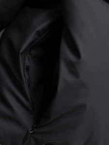 Detail of waterproof black padded jacket showing the zipper pocket and fabric texture
