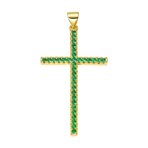 Detailed macro of a gold cross pendant set with vibrant green cubic zirconia stones