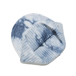 Detailed view of the thick ribbed knit texture on a blue and white tie-dye beanie