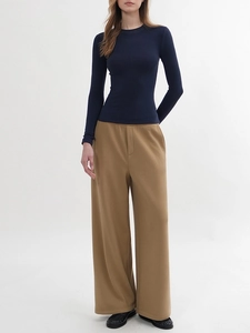 Slim fit navy crew neck long sleeve top paired with draped khaki wide leg trousers