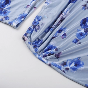 Detailed close-up of blue rose print fabric with pleated stitching and silk texture
