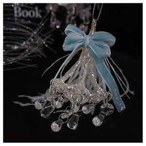 Detailed macro view of light blue velvet bow with silver glitter and crystal pendants